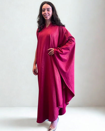 Woman wearing a burgundy dress against a white background