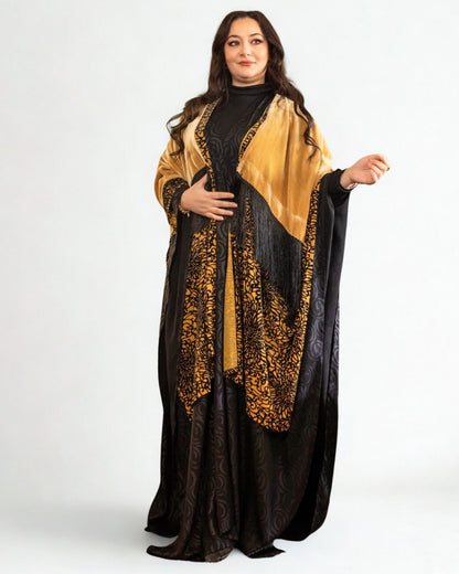 Woman wearing a black and gold abaya on a white background
