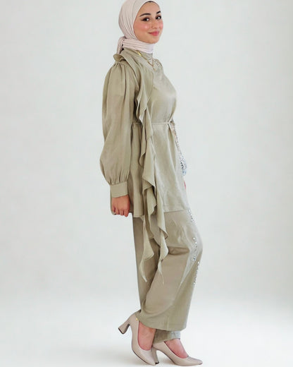 Woman wearing a beige outfit with a hijab on a white background