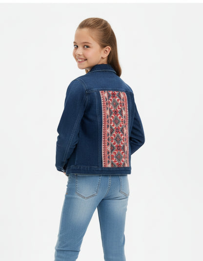 Girl wearing a blue denim jacket with a colorful embroidered back panel on a white background