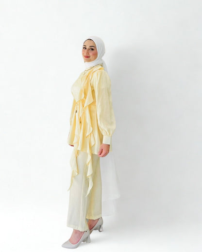 Woman wearing a light yellow outfit with a hijab on a white background