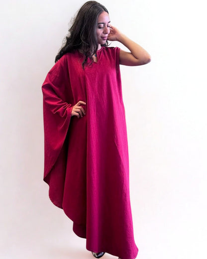 Woman wearing a red dress with a plain background