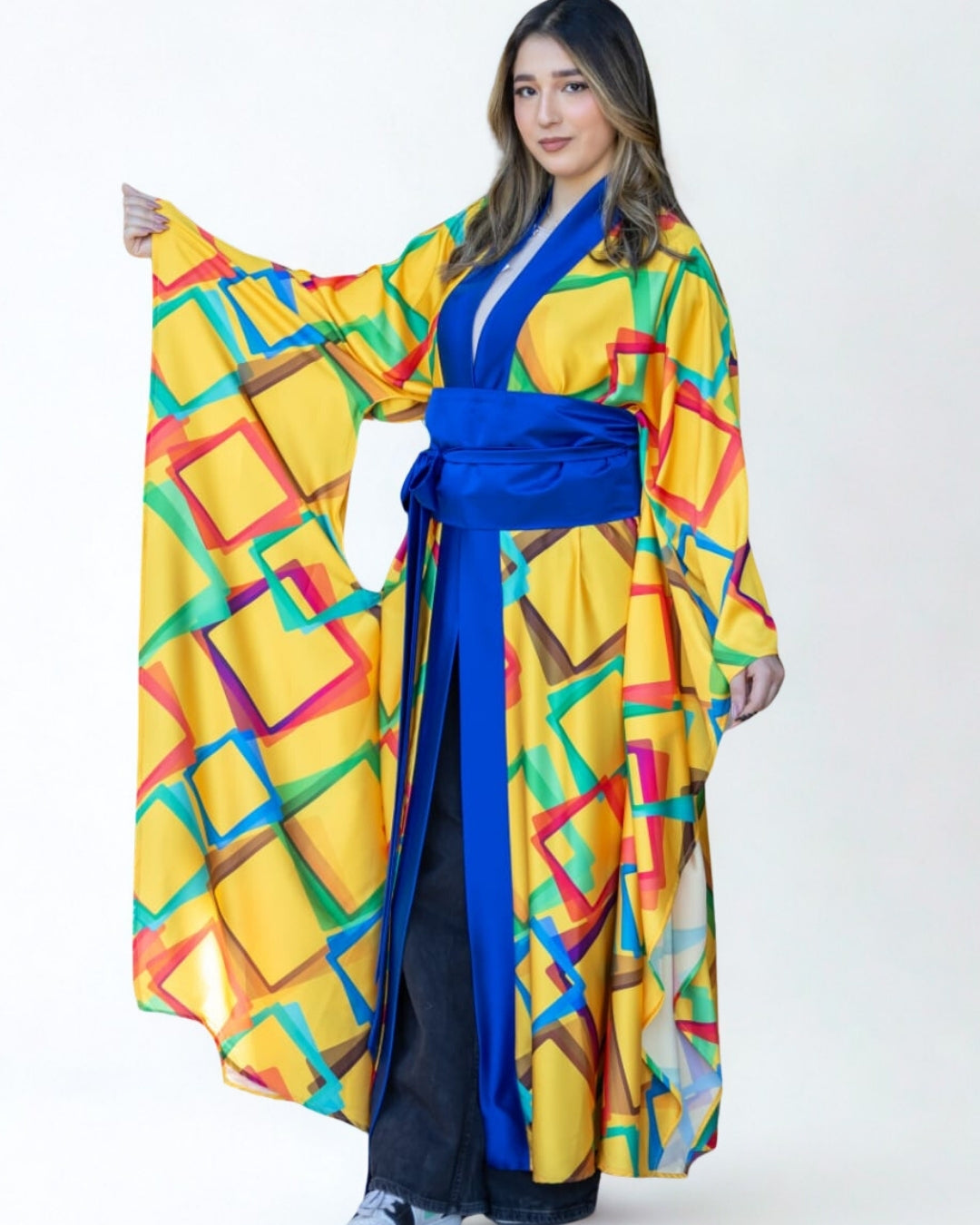 Woman wearing a colorful kimono with geometric pattern on a white background