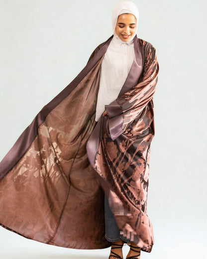 Woman wearing a large brown patterned scarf on a white background
