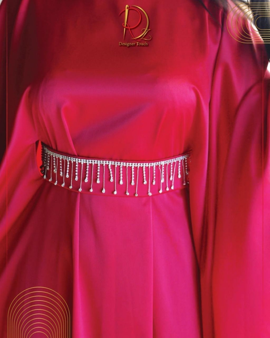 Red dress with a decorative belt featuring a brand logo.