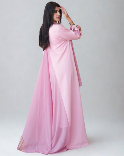 Woman wearing a pink dress against a white background