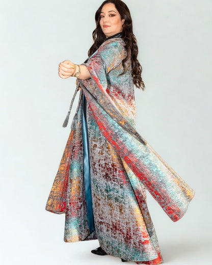 Woman wearing a colorful, patterned dress on a white background