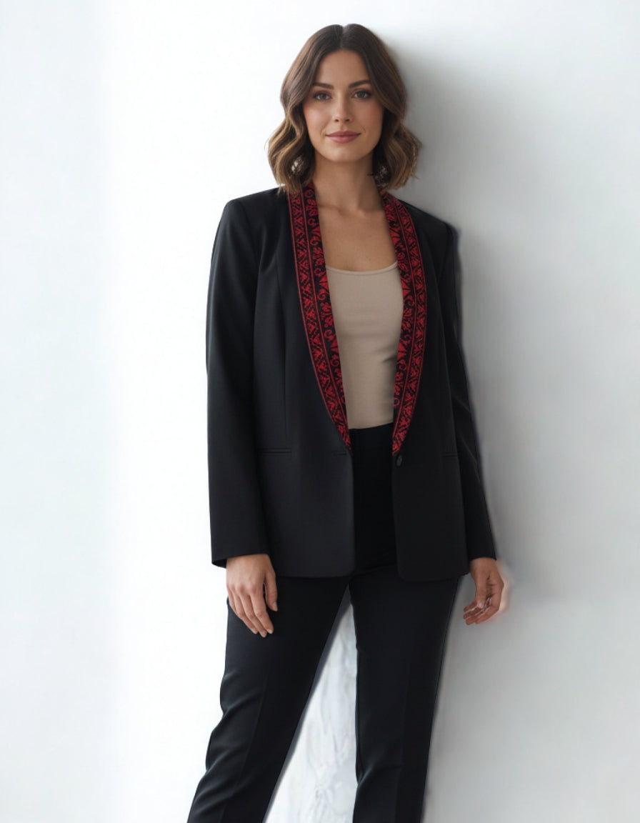 Woman wearing a black blazer with red trim against a white background