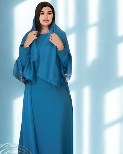 Woman wearing a blue dress against a light blue background