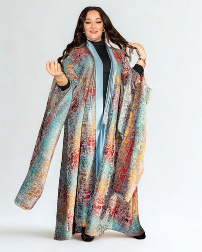 Woman wearing a colorful patterned coat on a white background