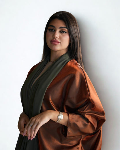 Woman wearing a brown and green scarf against a white background