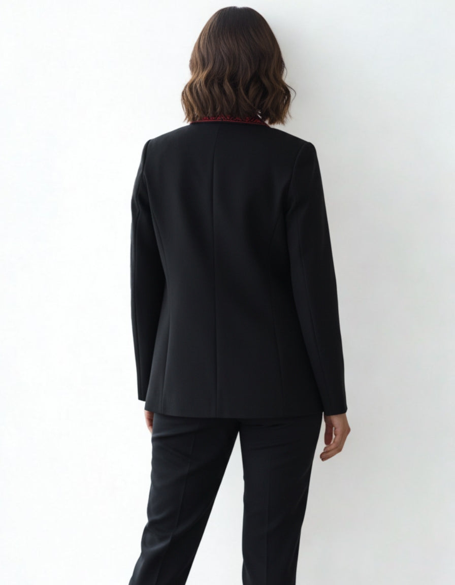 Person wearing a black suit against a white background