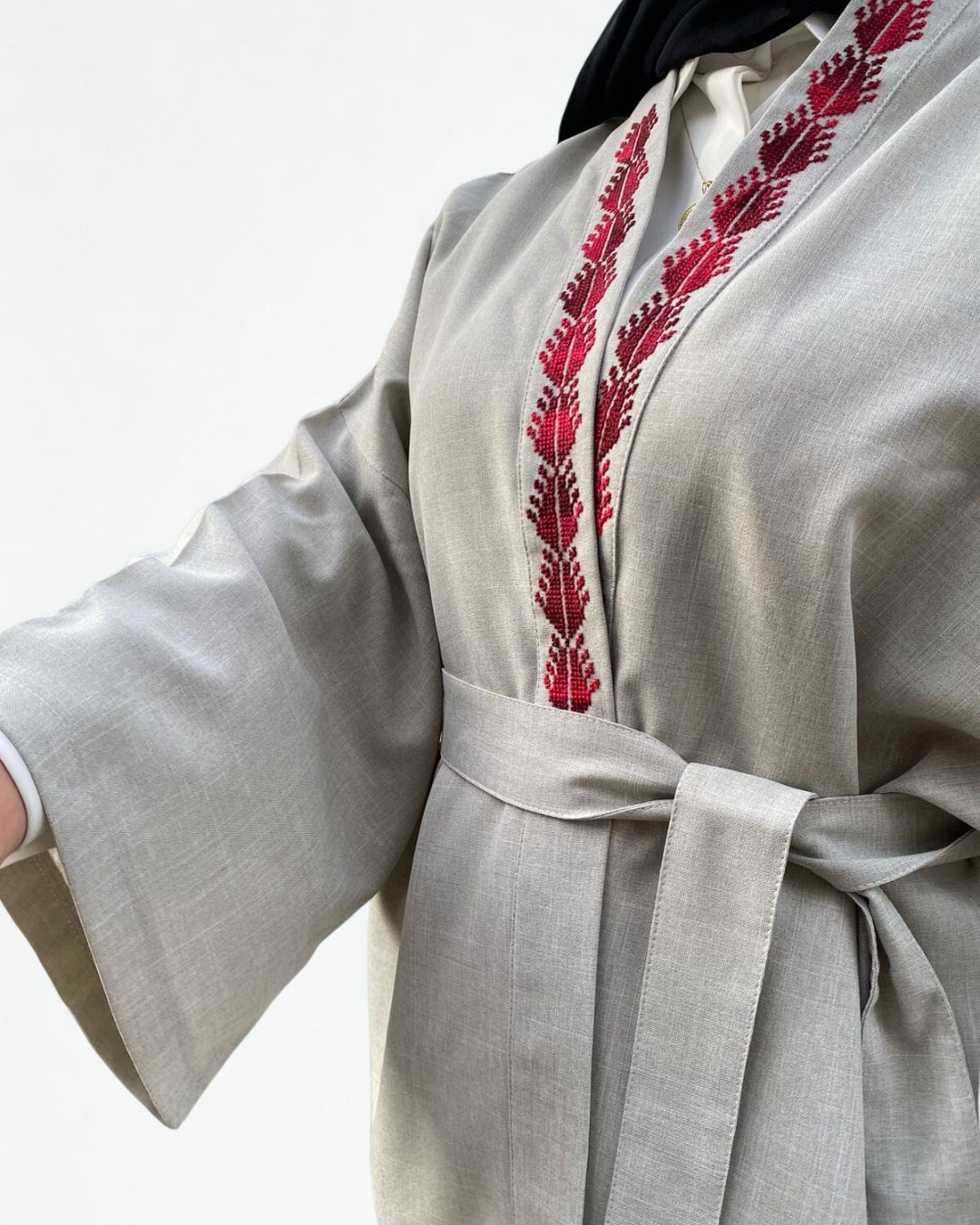 Light gray robe with red embroidery on a white background
