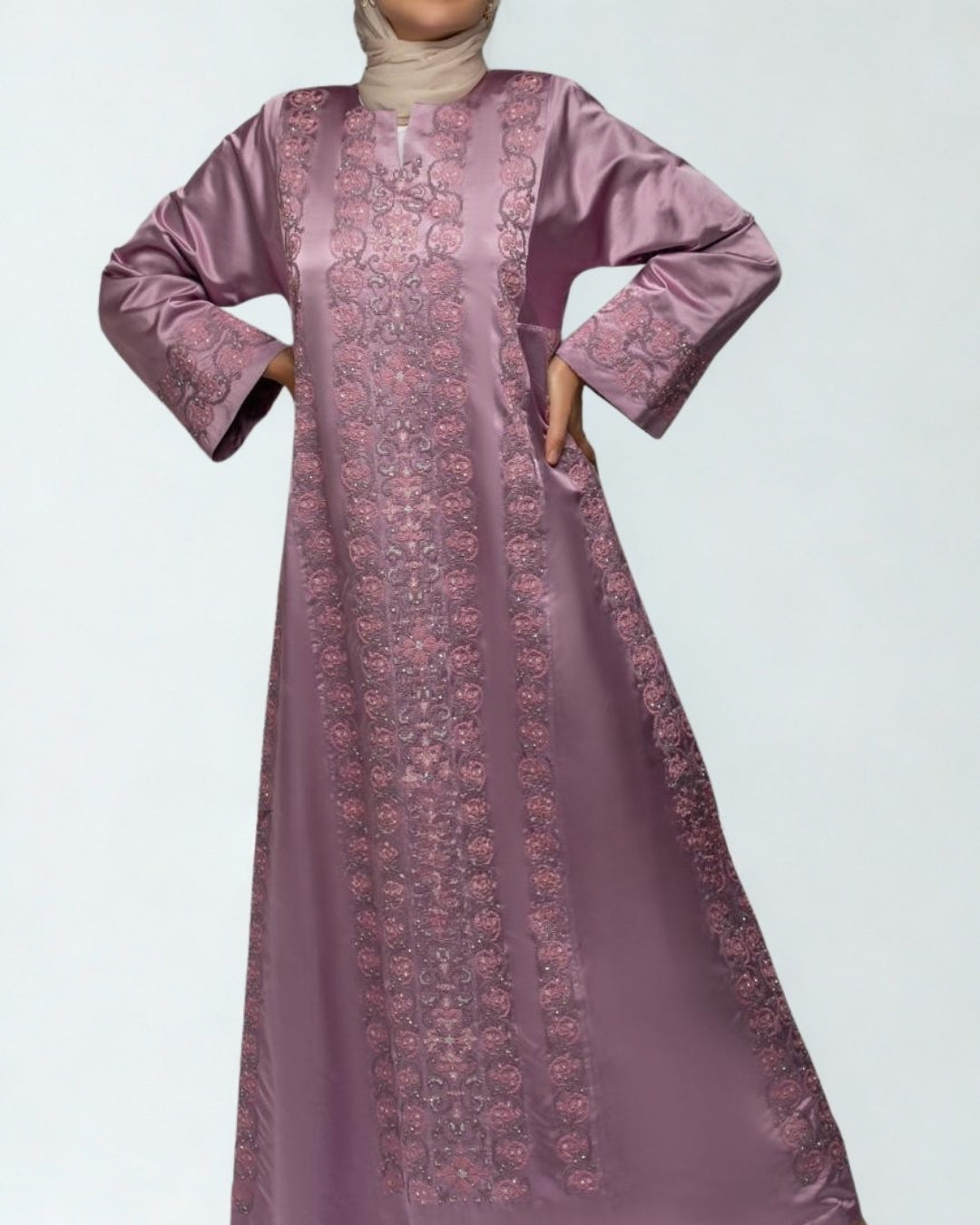 Long mauve dress with intricate patterns on a light gray background