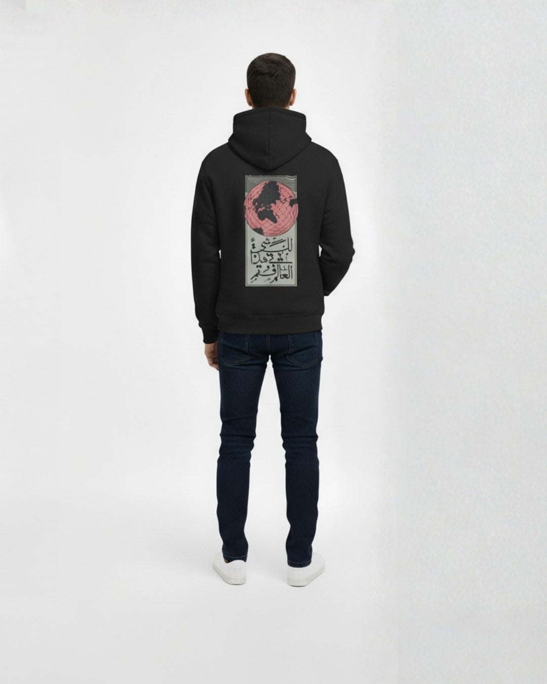 Person wearing a black hoodie with a graphic design on the back against a white background