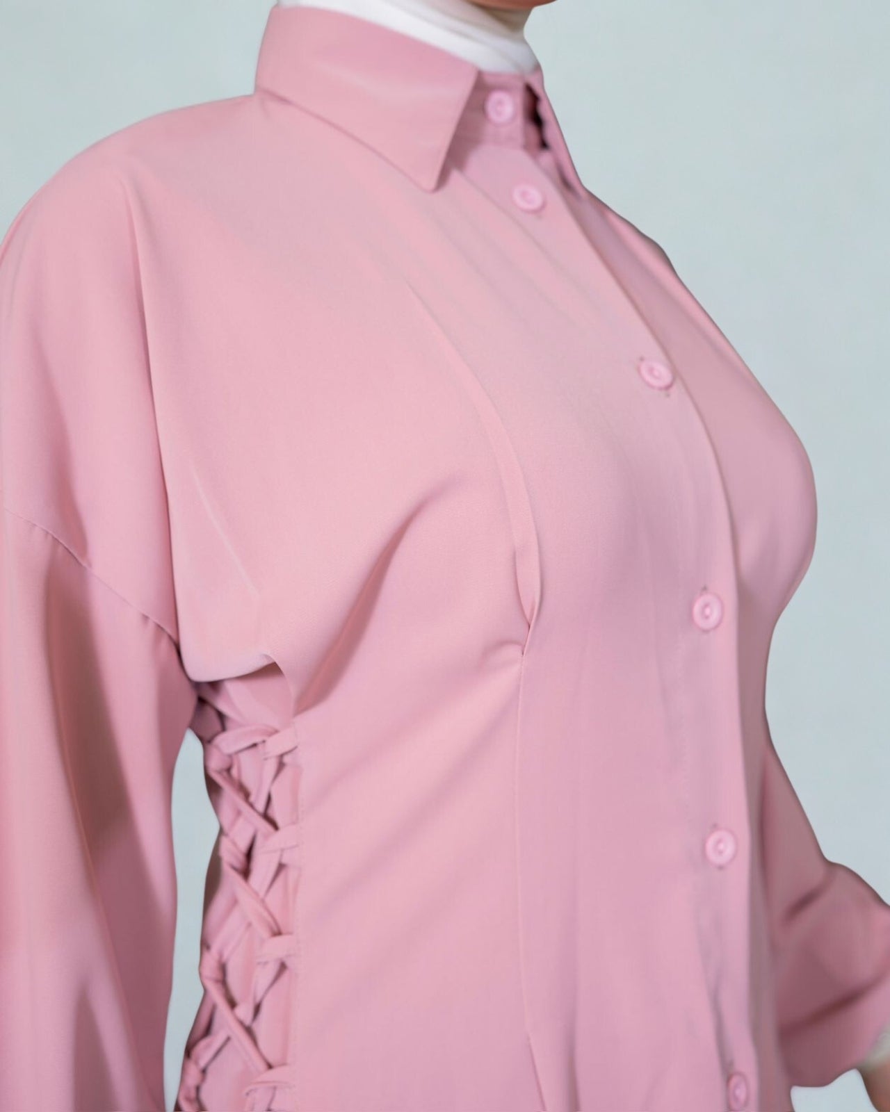 Pink blouse with a white collar on a light gray background