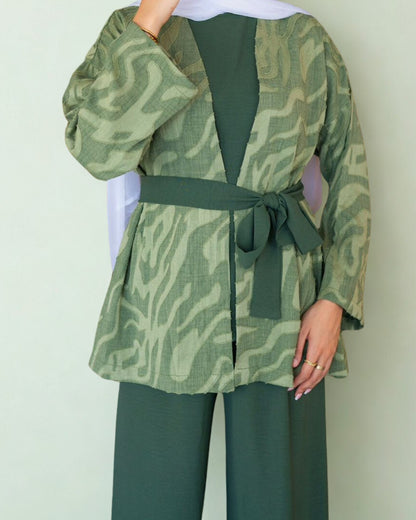 Green patterned jacket with matching pants on a plain background