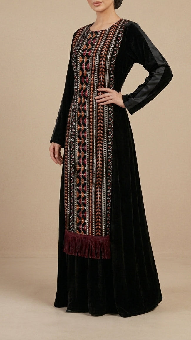 Woman wearing a black dress with intricate embroidery on a beige background