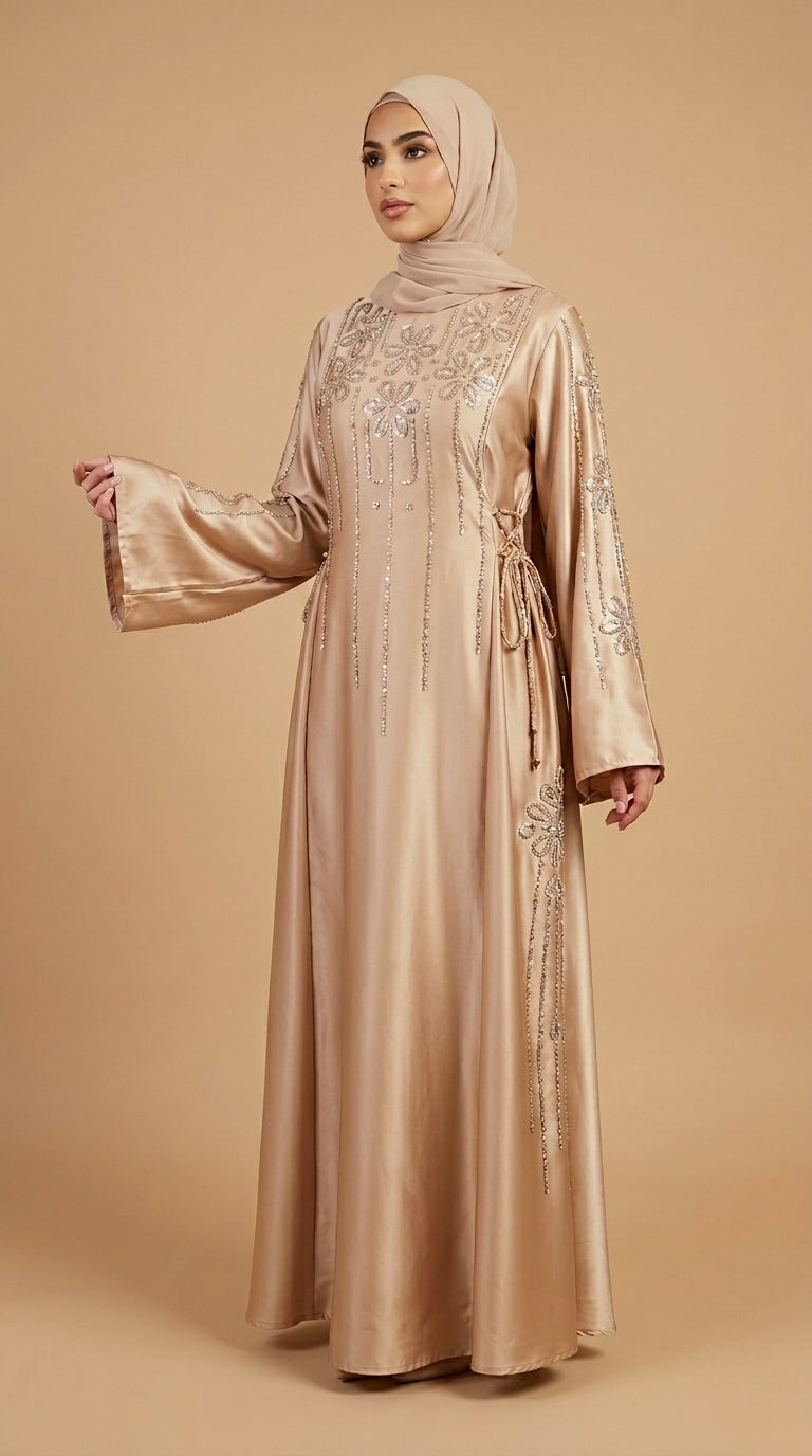 Woman wearing a beige embroidered dress and hijab on a beige background