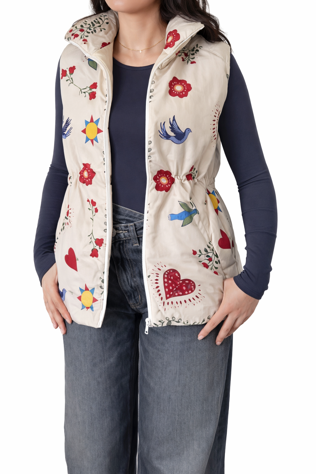 Person wearing a floral embroidered vest with a plain background