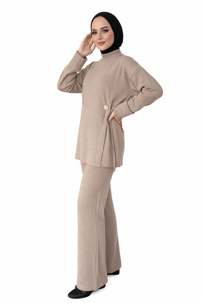 Woman wearing a beige outfit with a hijab on a white background