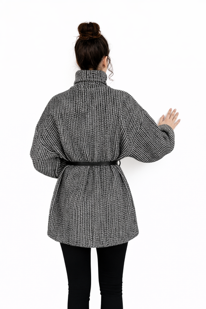 Person wearing a gray checkered coat on a white background