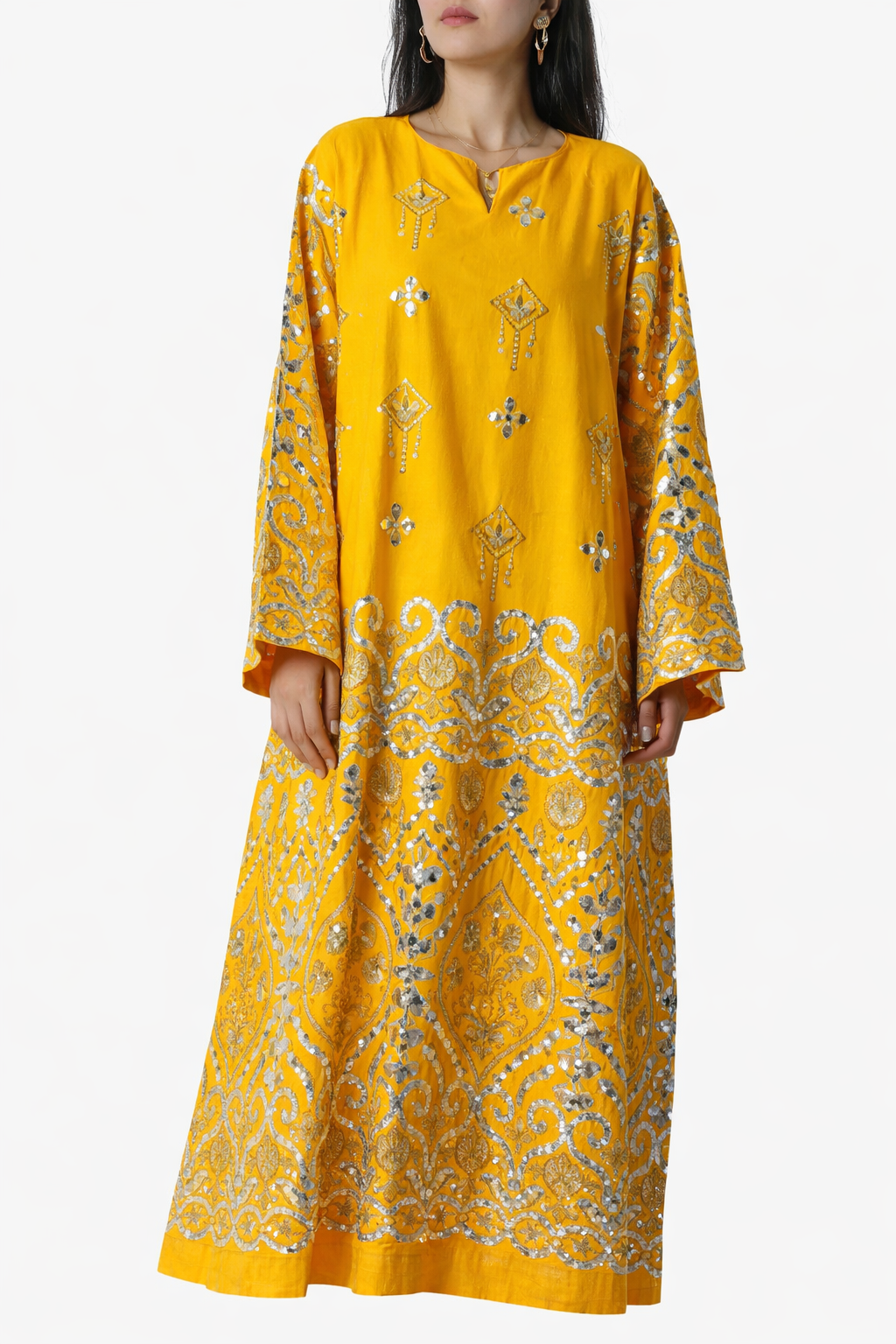 Woman wearing a yellow floral dress on a white background