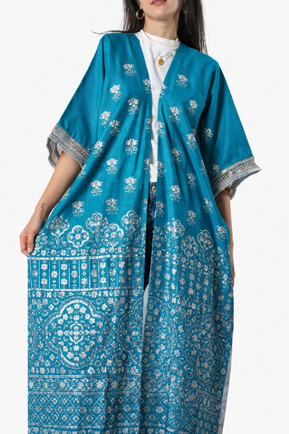 Woman wearing a blue patterned dress with a white background