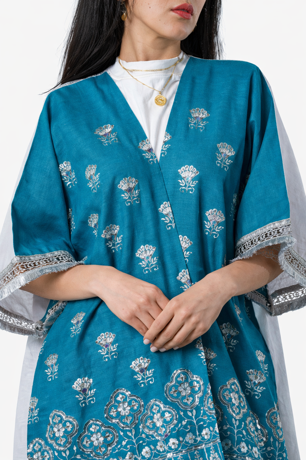 Woman wearing a blue embroidered traditional outfit with white inner lining