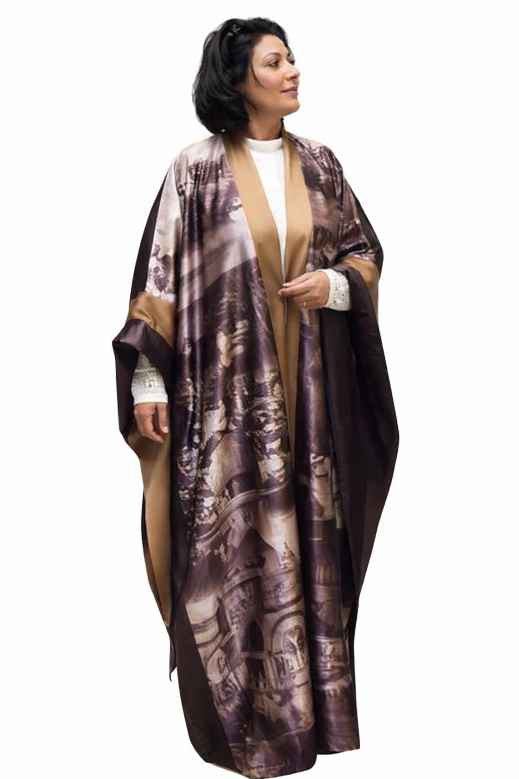 Woman wearing a long, patterned robe over a white outfit on a white background