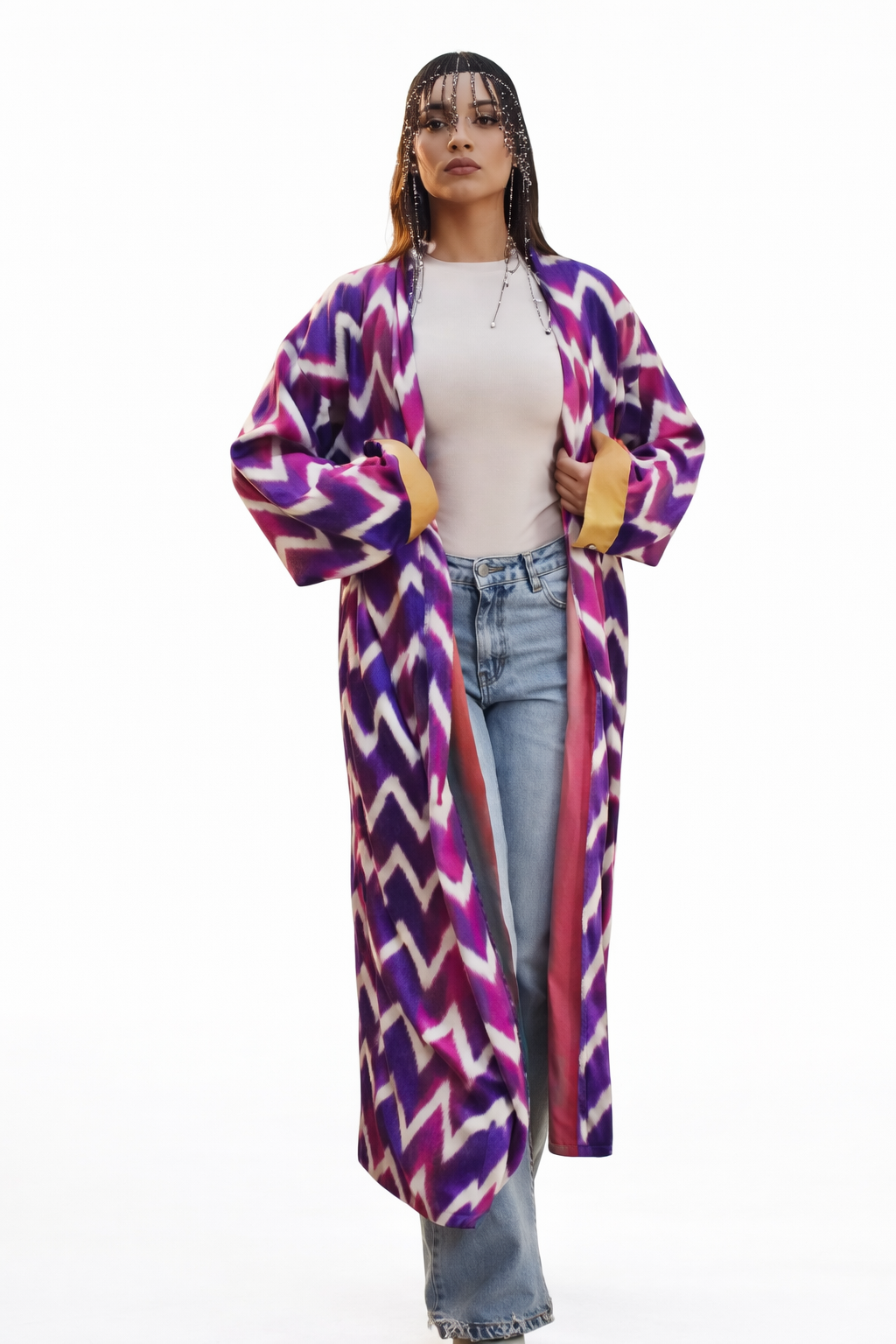 Person wearing a colorful patterned coat on a white background