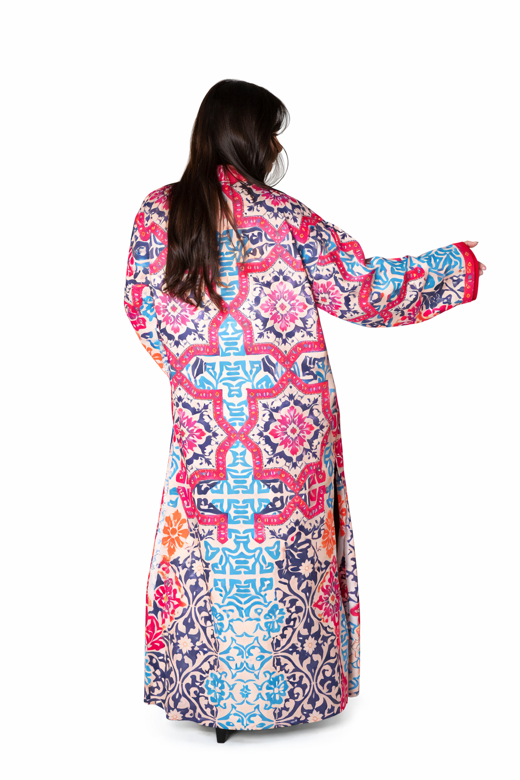 Woman wearing a colorful patterned dress on a white background