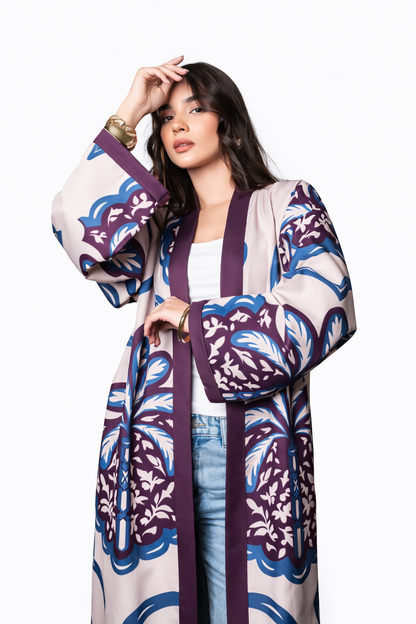 Woman wearing a patterned kimono-style outfit on a white background