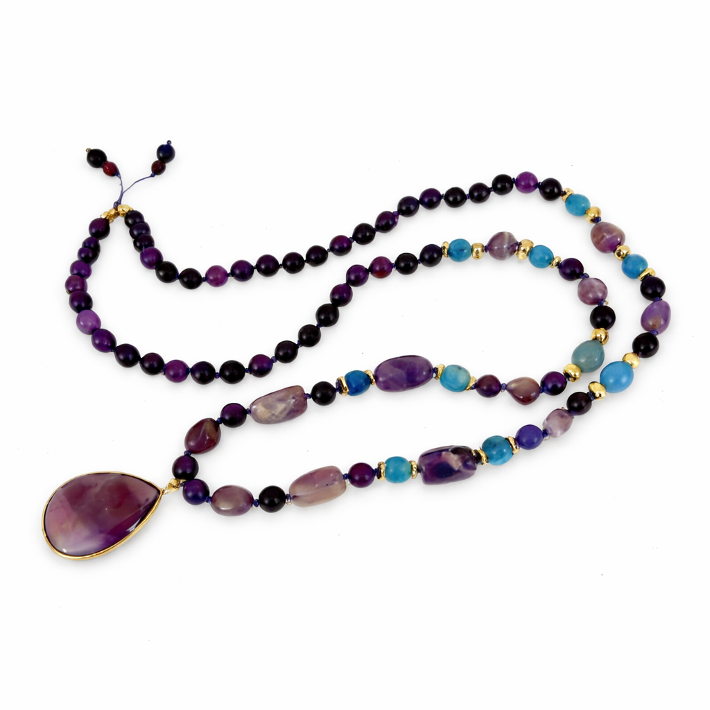 Multicolored beaded necklace with a teardrop pendant on a white background