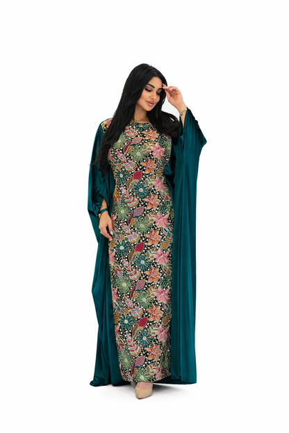 Woman wearing a floral dress with a green cover-up on a white background