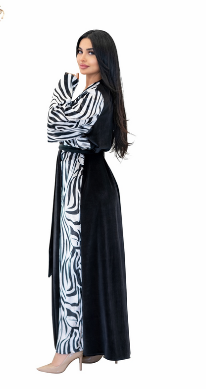 Woman wearing a black and white zebra patterned dress on a white background