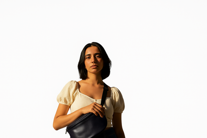 Woman holding a black bag against a white background