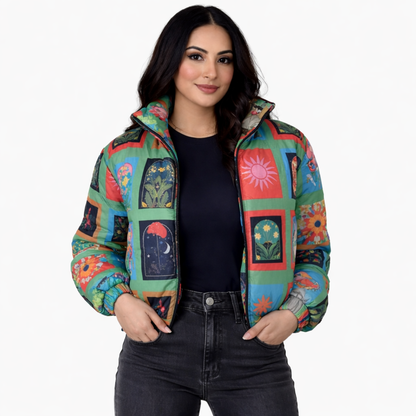 Woman wearing a colorful quilted jacket with geometric patterns on a white background