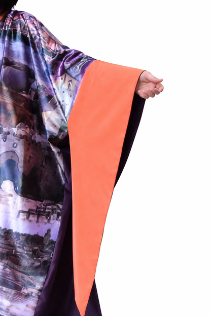 Colorful scarf with abstract patterns and an orange strip held by a hand on a white background