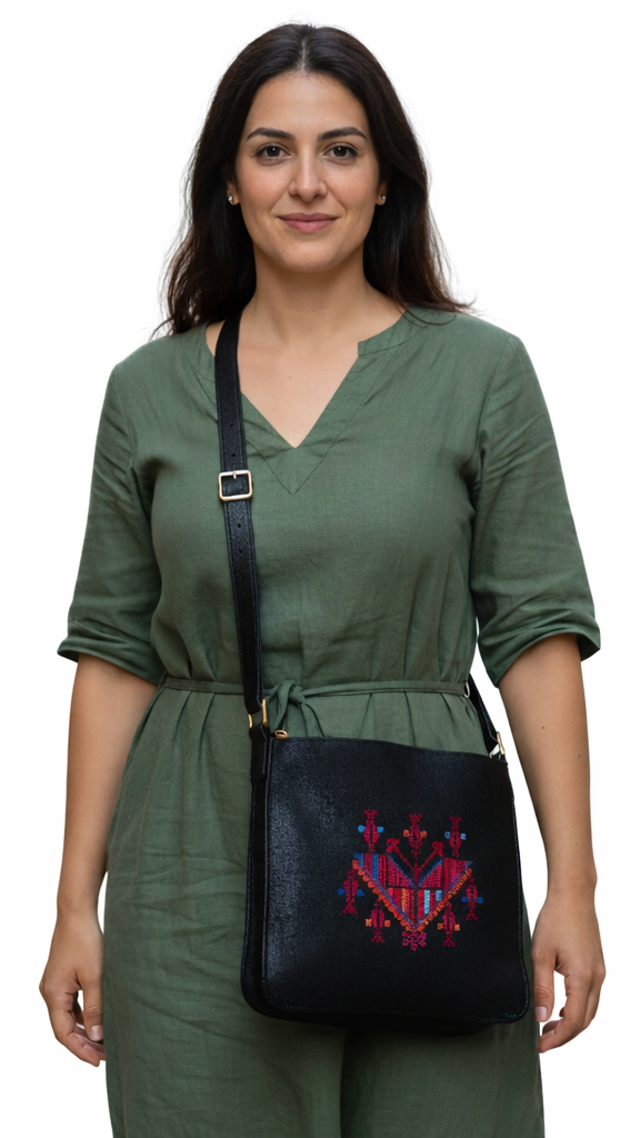 Woman wearing a green outfit with a black bag featuring red patterns on a white background