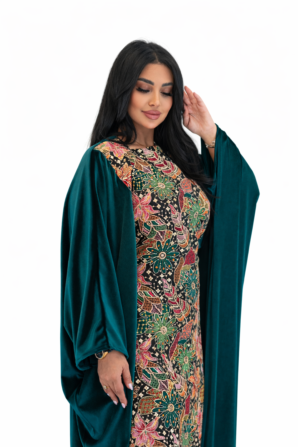 Woman wearing a floral dress with a green cover-up on a white background