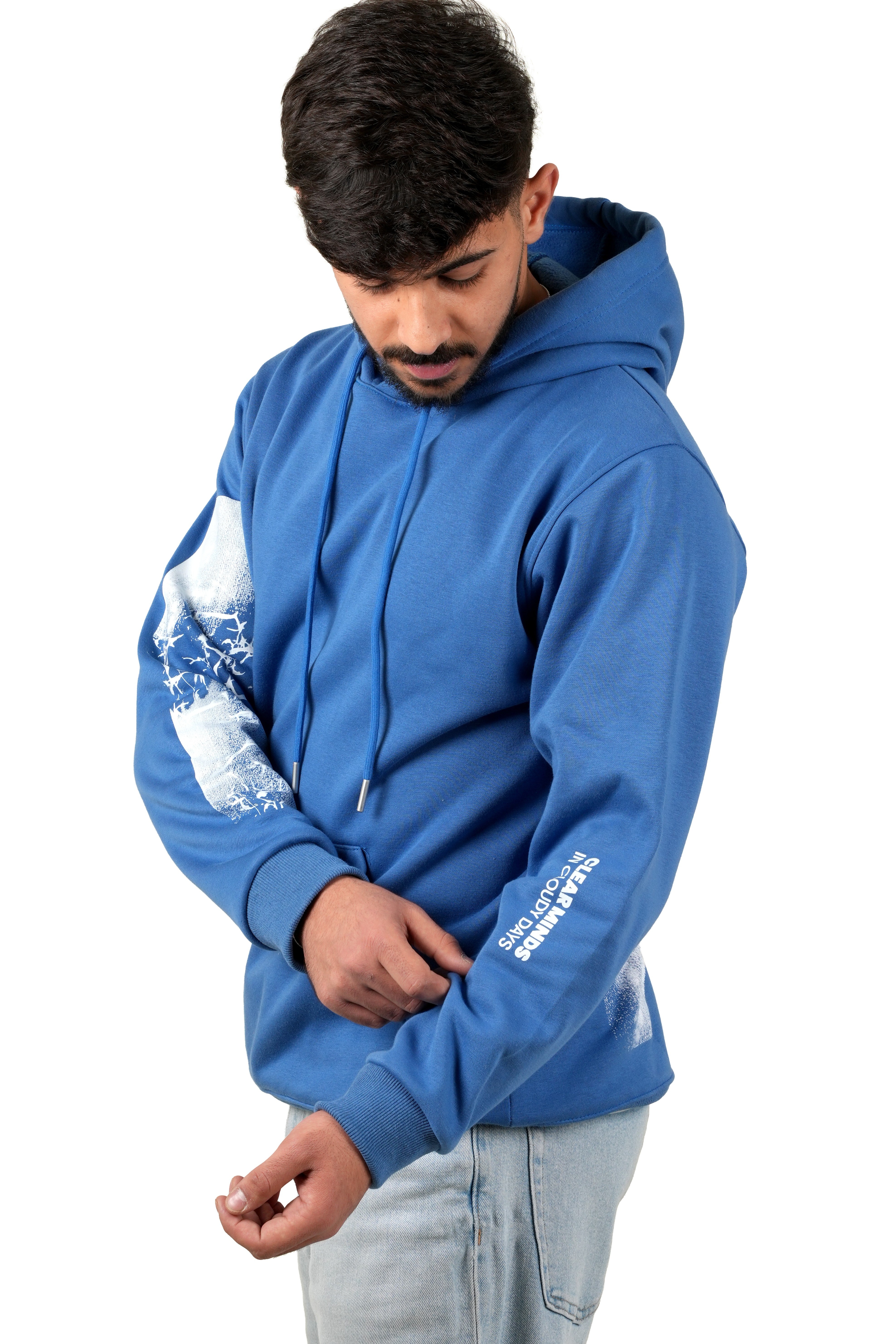 Person wearing a blue hoodie with white designs on sleeves against a white background