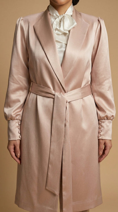 Pink satin coat with a white shirt underneath on a beige background