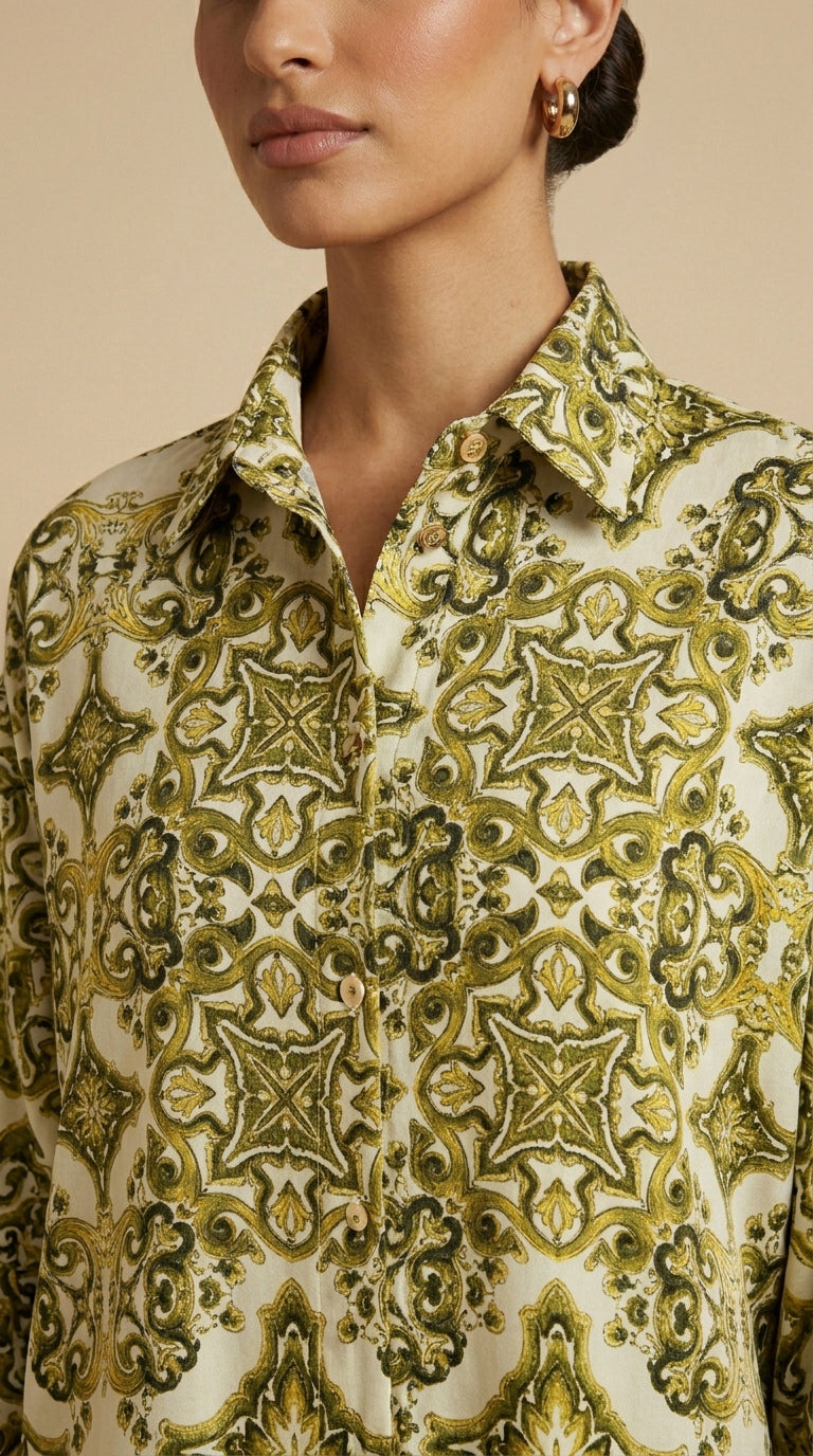 Close-up of a person wearing a patterned shirt with green and beige design.