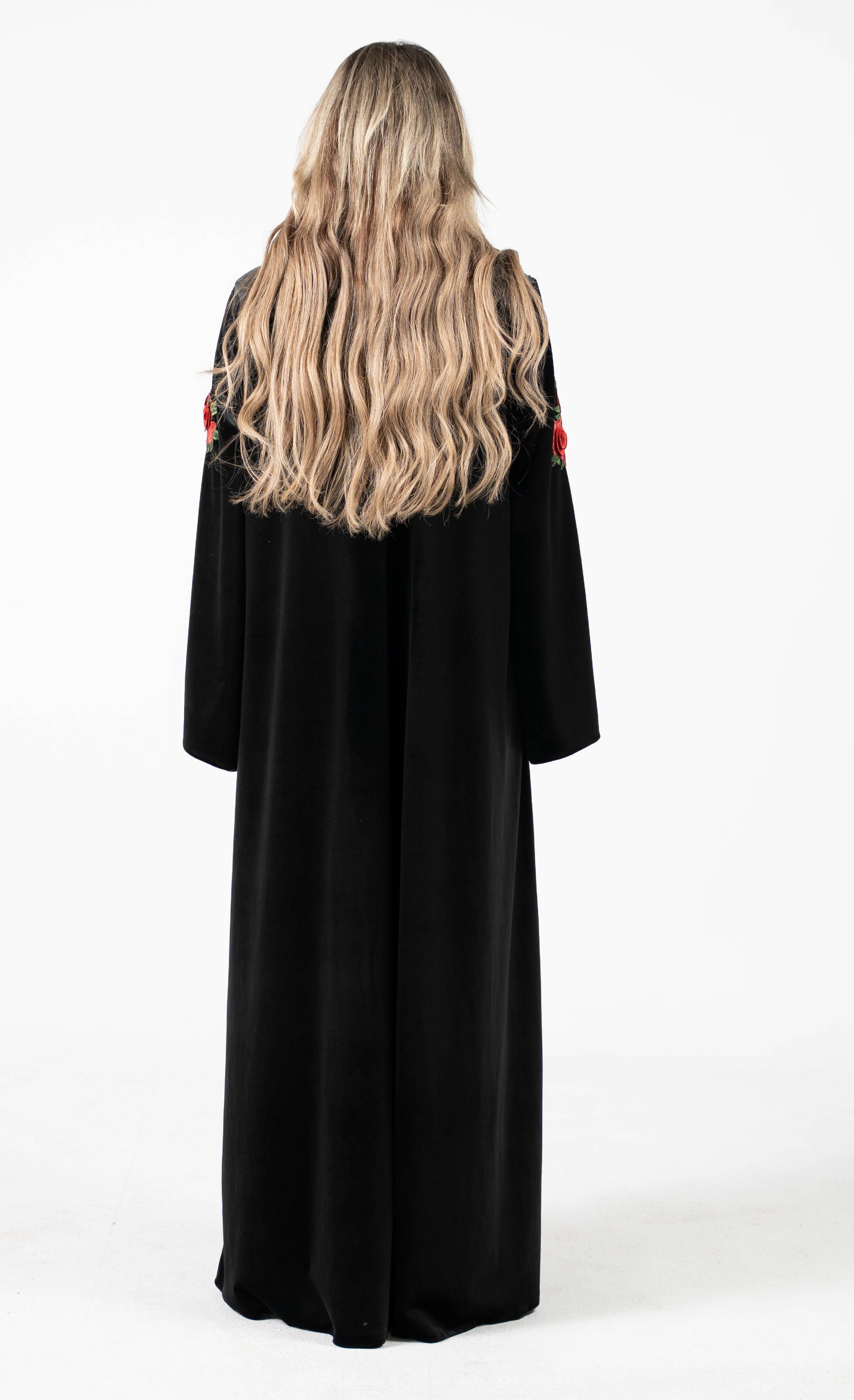 Black abaya with floral embellishments on a white background