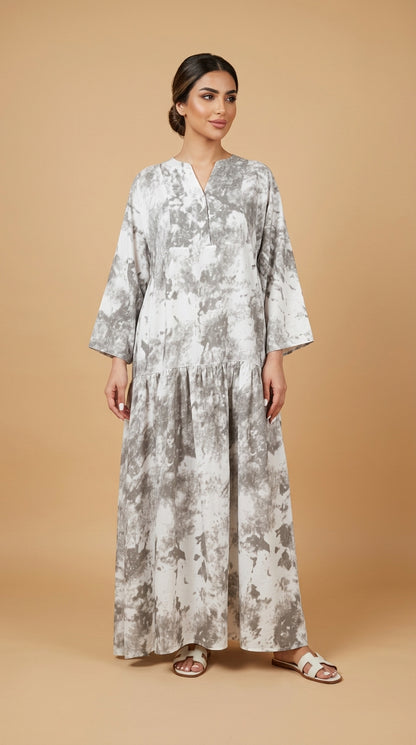 Woman wearing a floral dress against a beige background