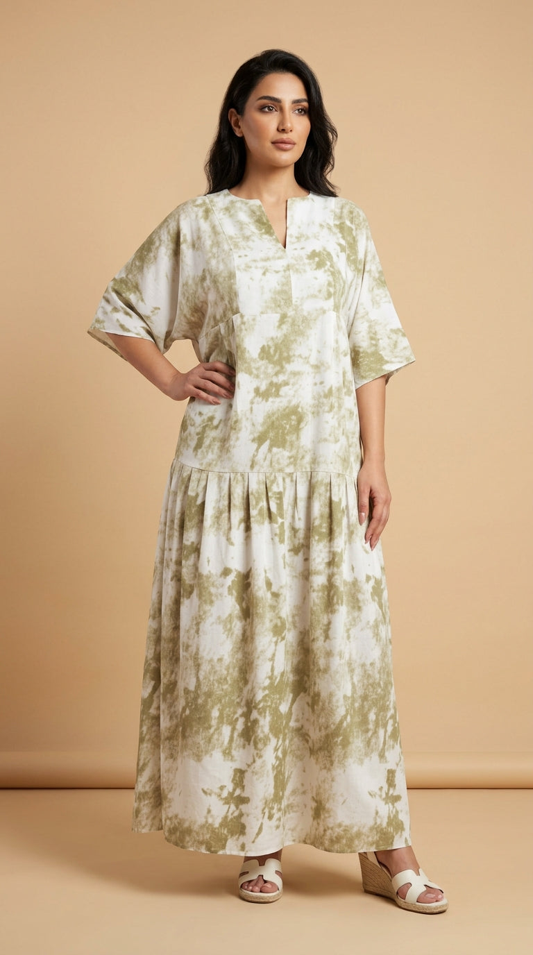 Woman wearing a long, light-colored dress with floral pattern against a beige background