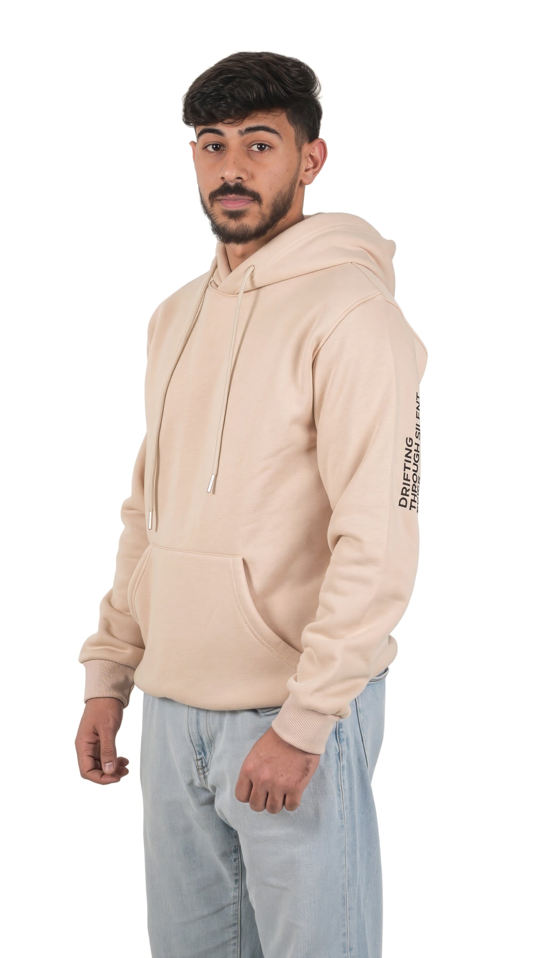 Man wearing a beige hoodie with text on sleeves against a white background