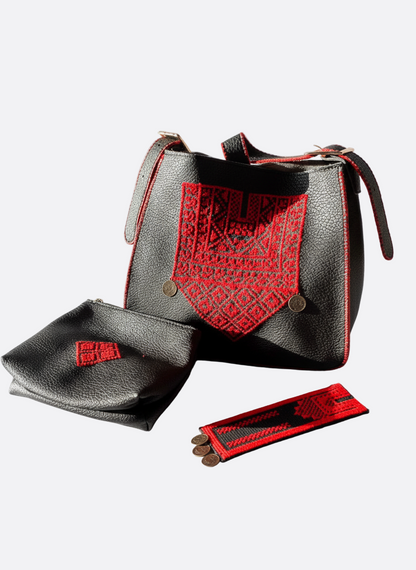 Black handbag with red accents and matching pouch on a white background