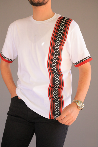 White t-shirt with red and black patterned shoulder strap worn by a person on a gray background